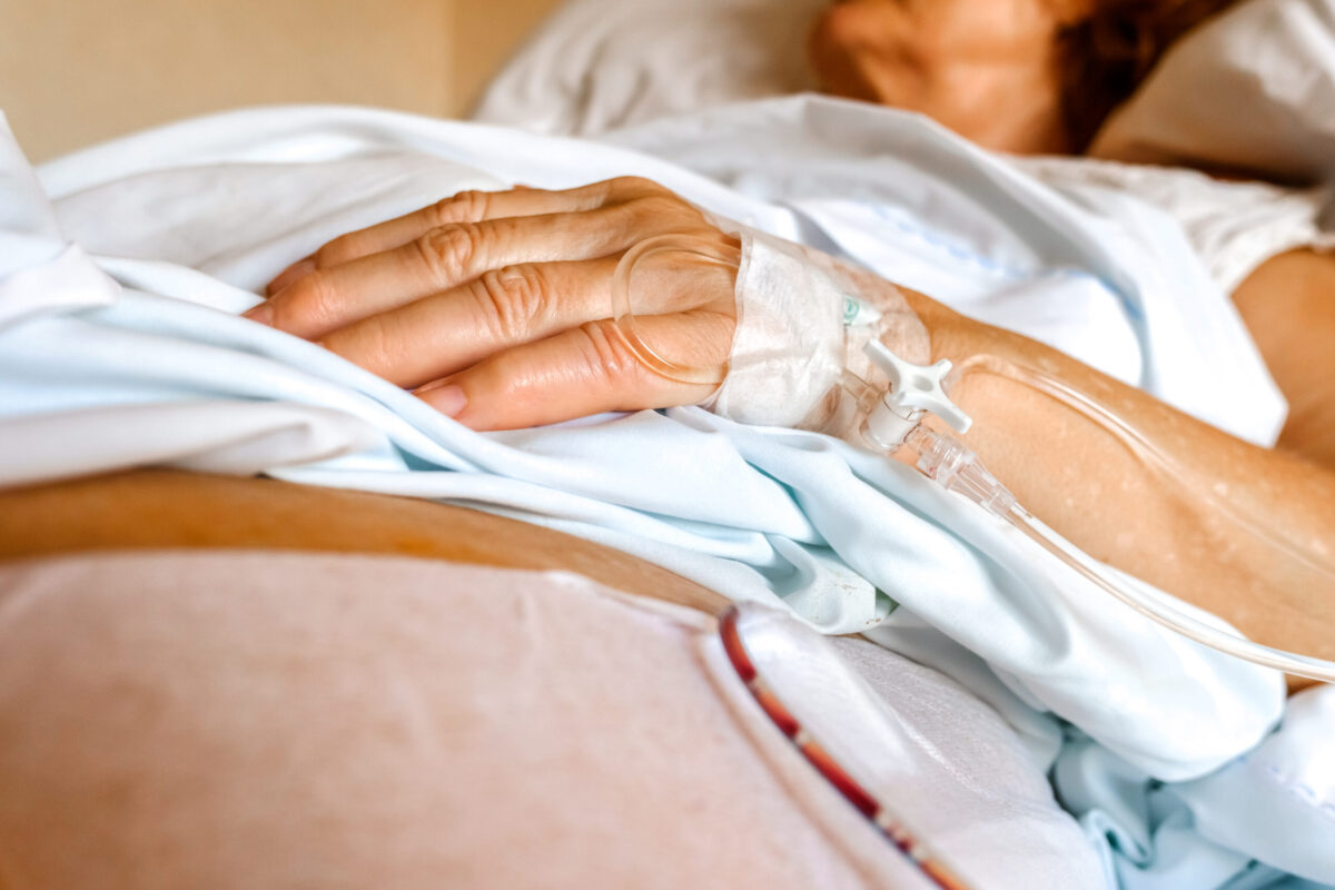 Intravenous cannula placed in the hand of an elderly patient for palliative care of a terminal patient.