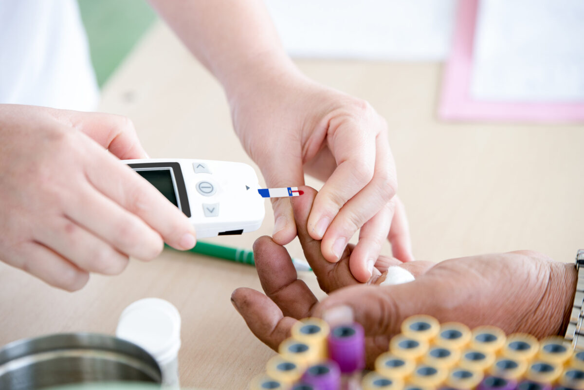 doctor testing blood in diabetes patient, fasting blood sugar