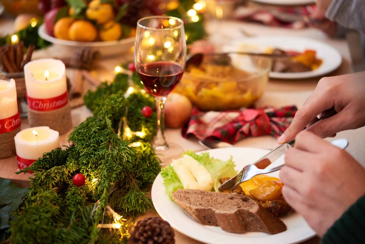 Guest eating delicious dishes at Christmas dinner