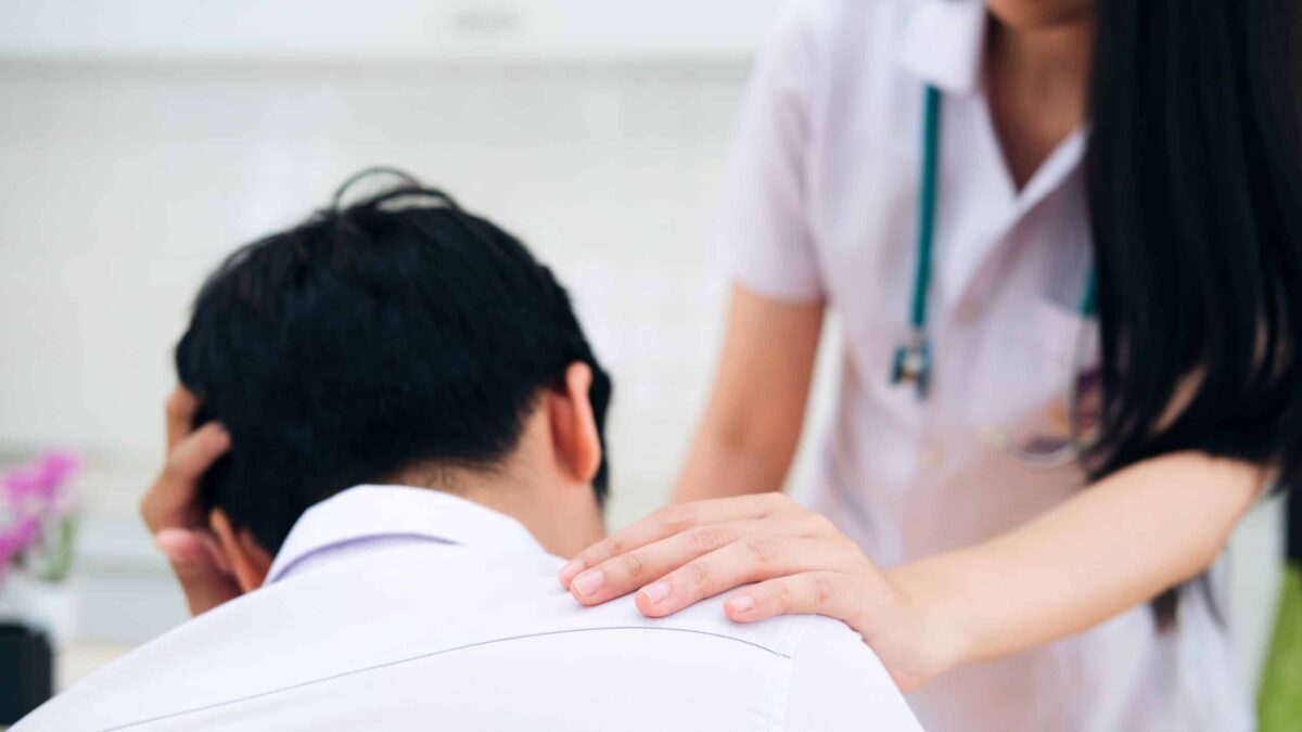 Doctor and patient. Doctor comforting patient at consulting room