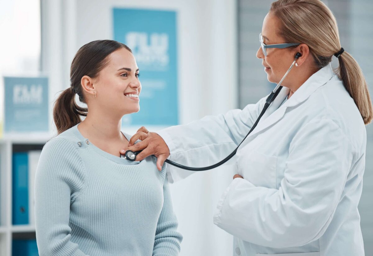 Shot of a doctor examining a patient with a stethoscope during a consultation in a clinic.