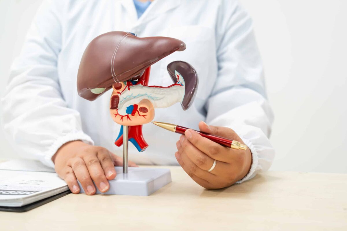 A female doctor works at a desk in hospital, discussing liver diseases like hepatitis B,cirrhosis